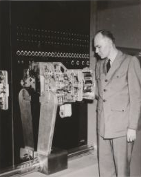 Howard Aiken with section of Mark I computer [Harvard University Archives, W360603_1]